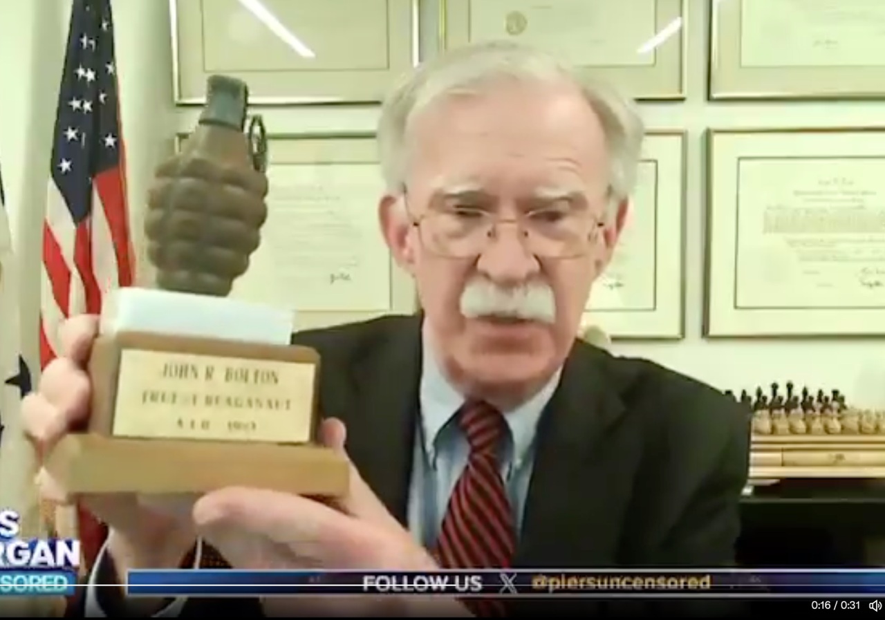 Bolton with plaque from usaid